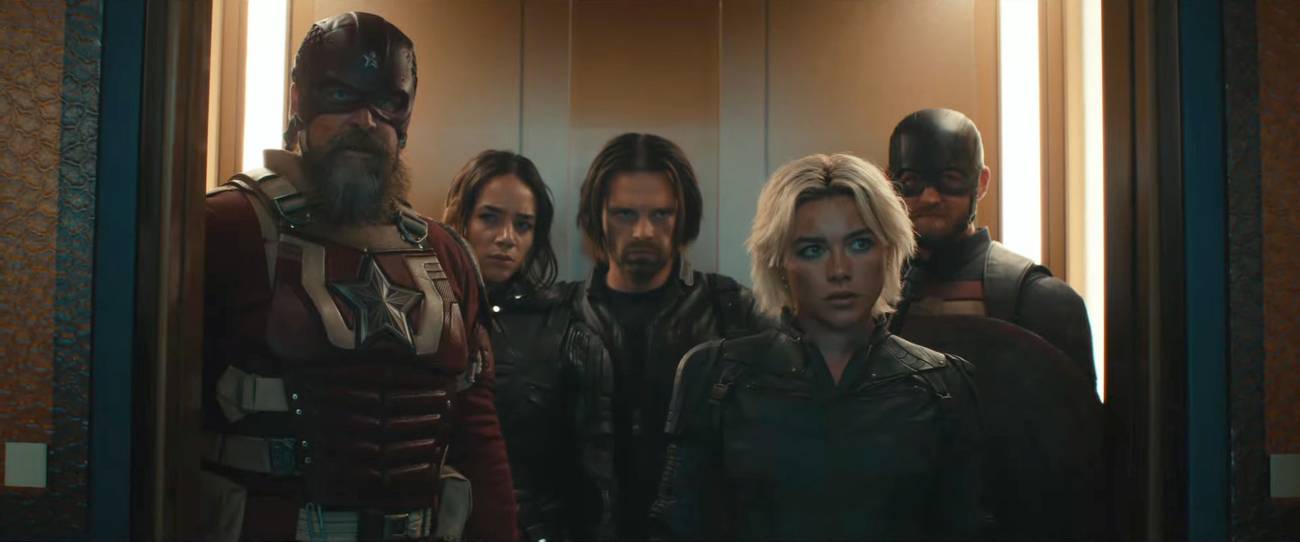 Yelena Belova/White Widow (Florence Pugh) reunites with father figure Alexei Shostakov/Red Guardian, then collides with U.S. Agent/John Walker (Wyatt Russell), Ghost/Ava Starr (Hannah John-Kamen), and the Winter Soldier/Bucky Barnes (Sebastian Stan) stand in an elevator in a still from Marvel’s Thunderbolts*