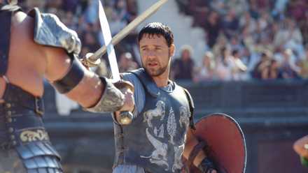 The gladiator Maximus (Russell Crowe) crosses swords with an opponent in the Colosseum in 2000’s Gladiator