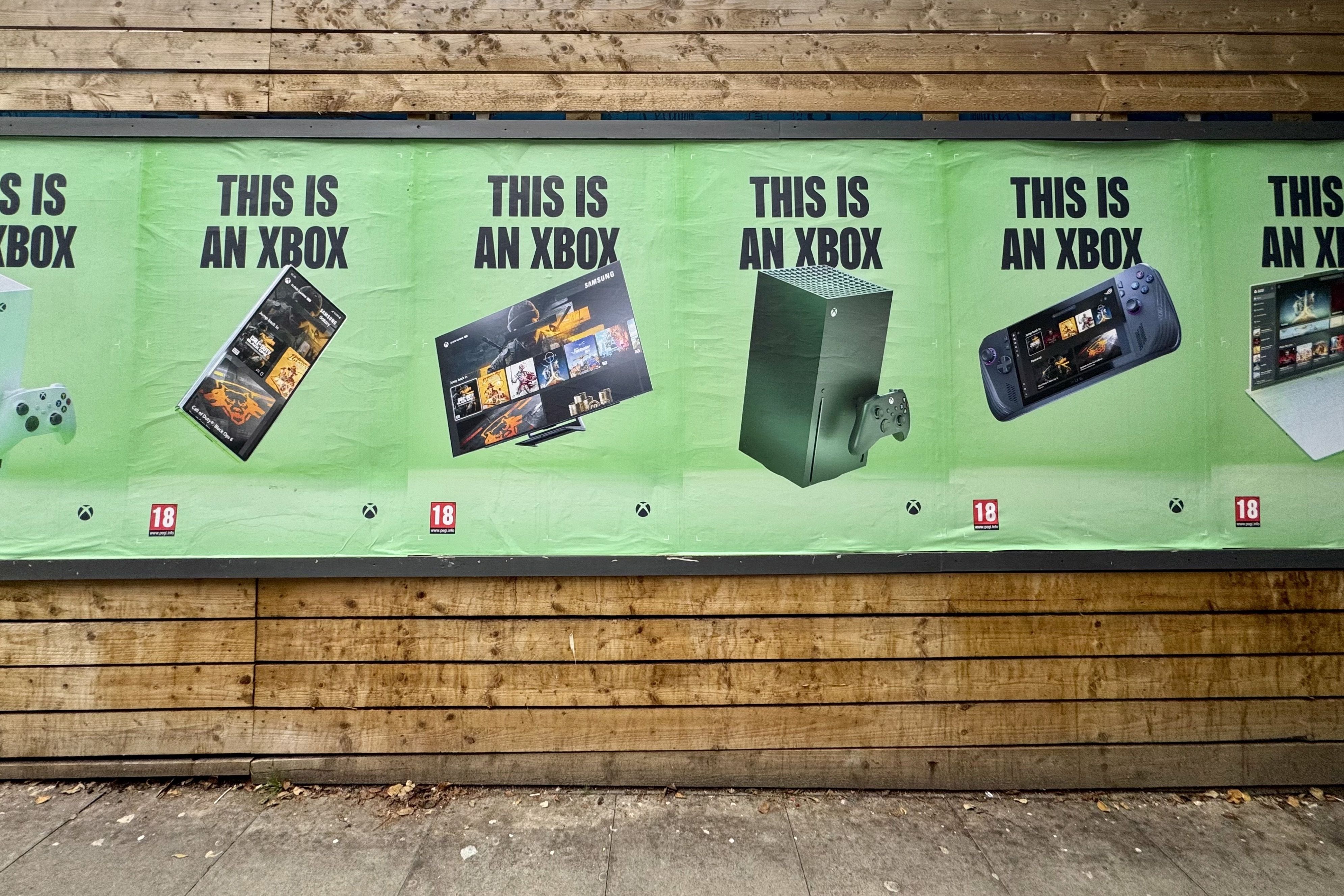A wall of green posters that all say “This is an Xbox” but with different devices below: a Series S, a phone, a TV, a Series X console, a handheld gaming device, and a laptop