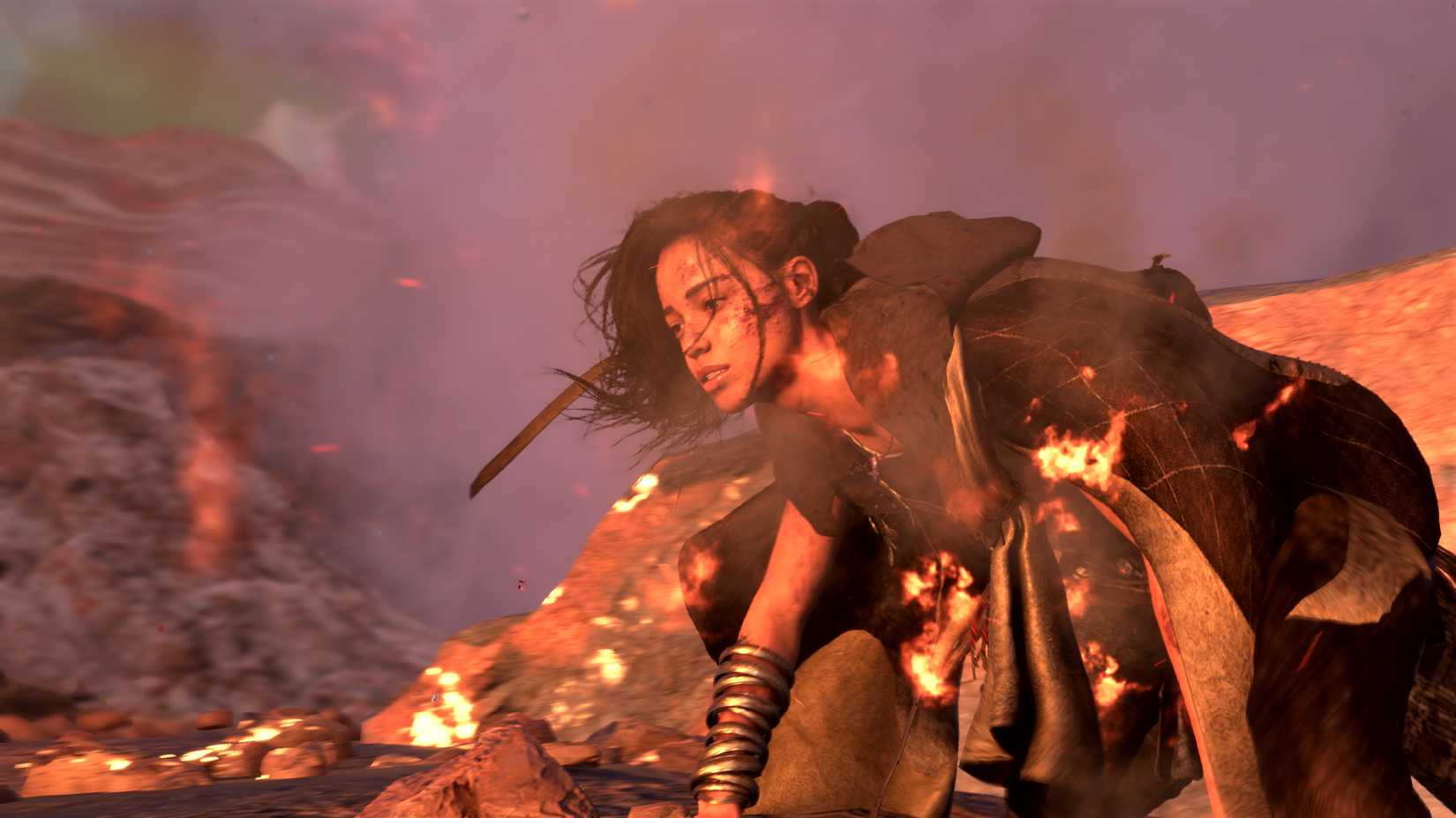A wide shot of Forspoken main character Frey wearing a cloak and hunched over in a bright scene