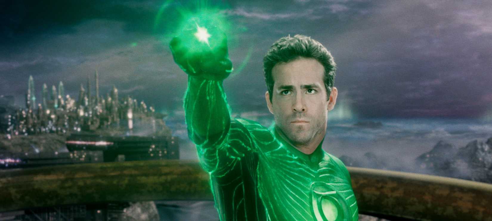 Ryan Reynolds, as the Green Lantern, holding up his green ring on an alien planet
