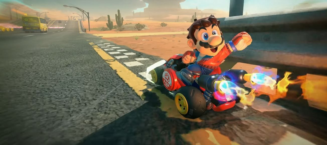 Mario in Mario Kart World looks back on the camera while riding in a straightaway.