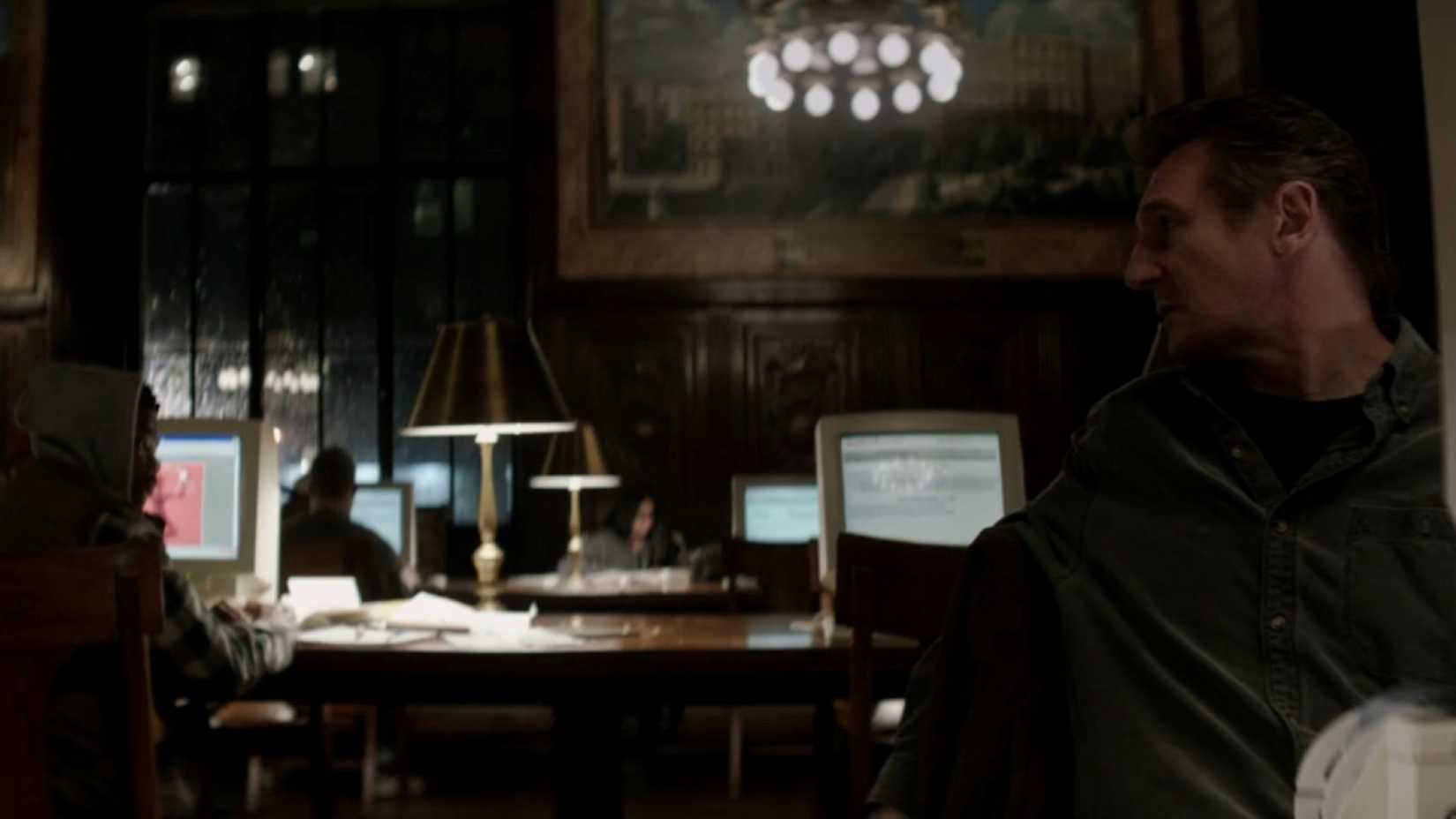 Liam Neeson does research at a public library in a scene from the film A Walk Among the Tombstones