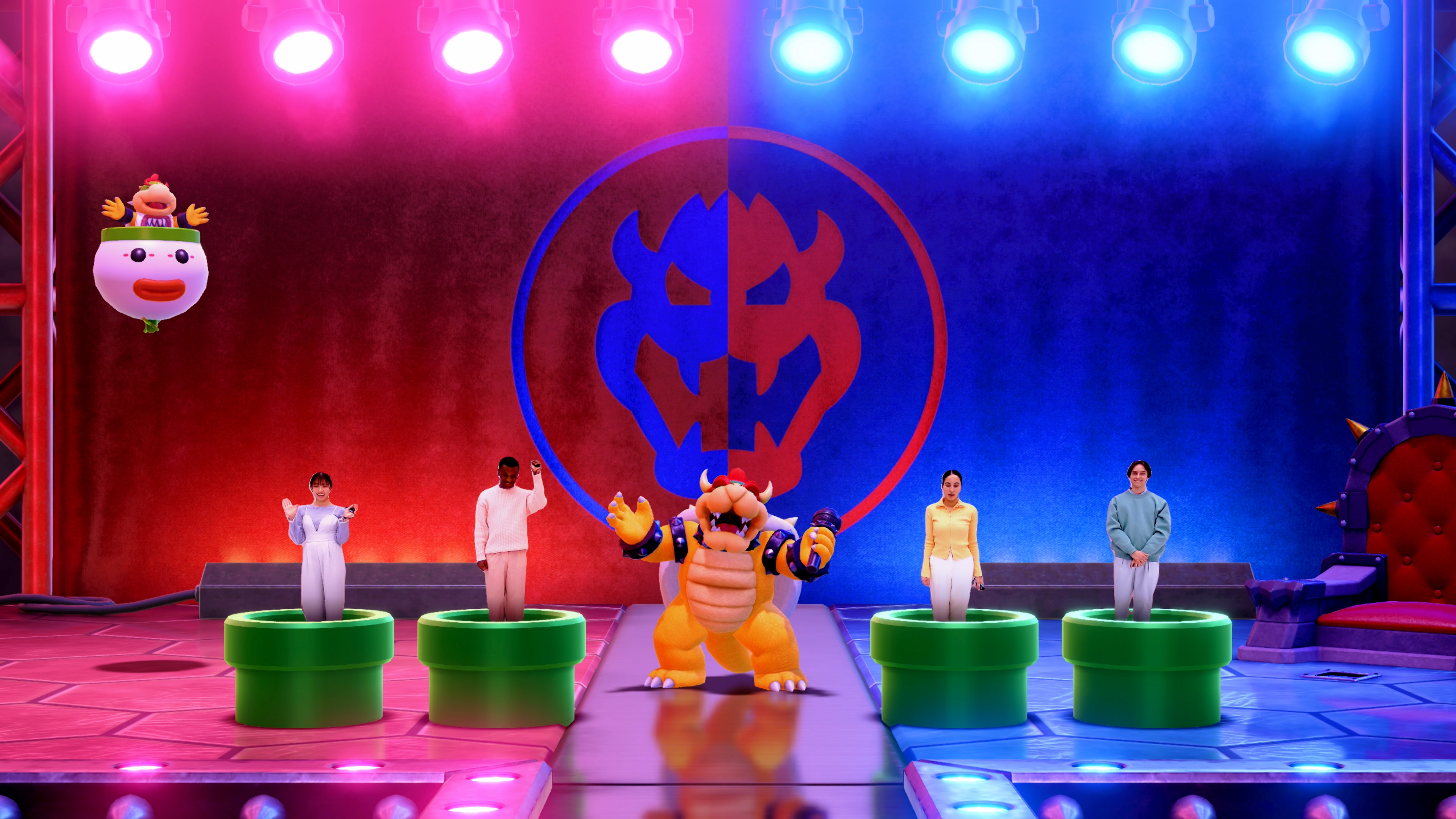 Bowser is surrounded by humans coming out of warp pipes in Super Mario Party Jamboree.