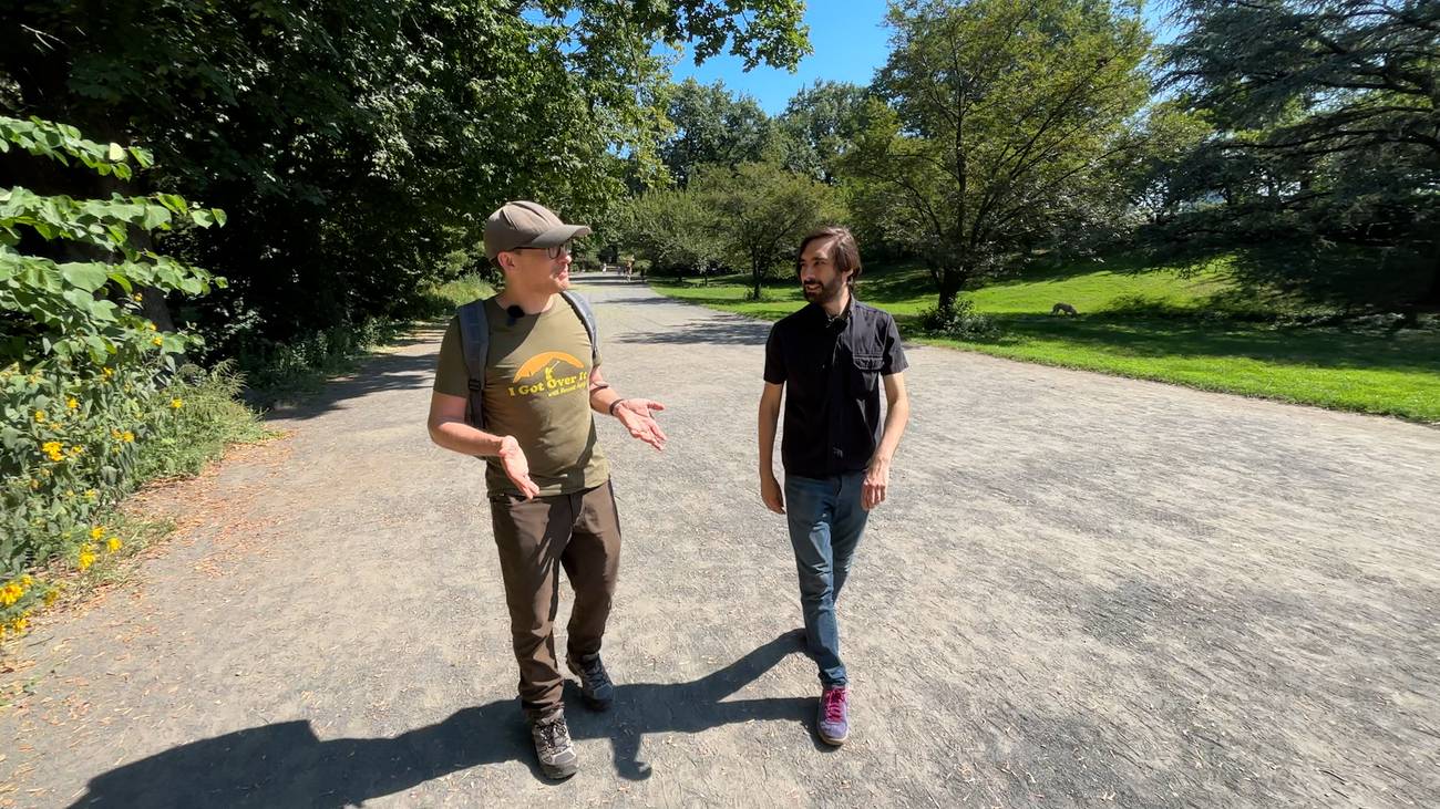 Bennett Foddy and Giovanni Colantonio walk down a gravel path.