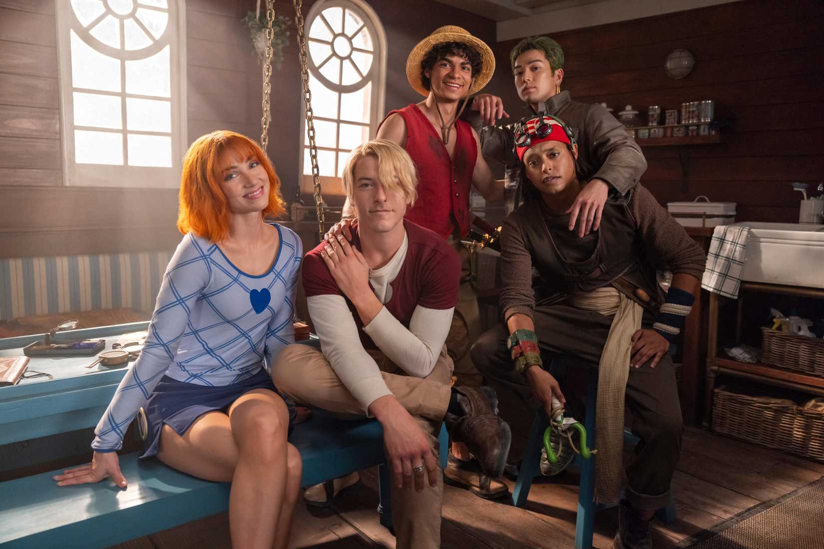 four men and a woman sit by each othe on set for Netflix's live-action One Piece season 2