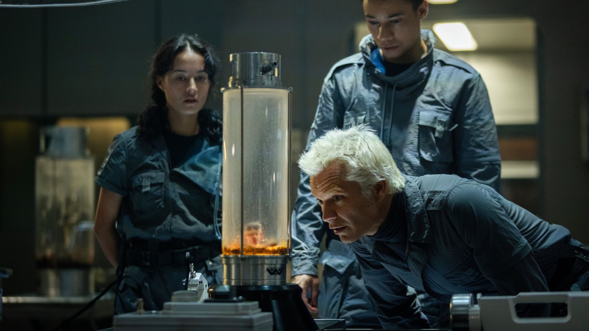 Curly, Isaac, and Kirsh examine the eyeball alien t. ocellus in its containment habitat.