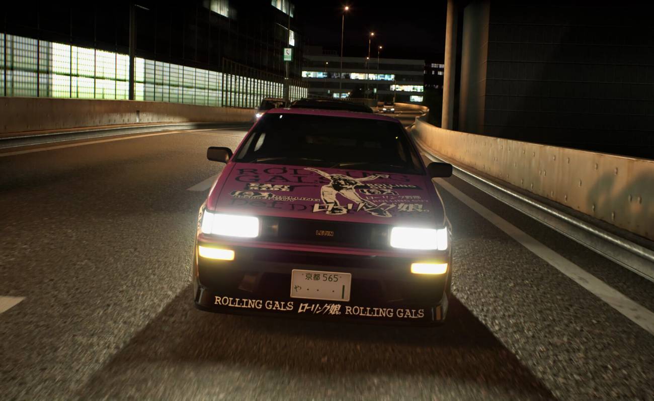 A pink, heaveily modified Toyota drives toward the camera at night in Tokyo Xtreme Racer