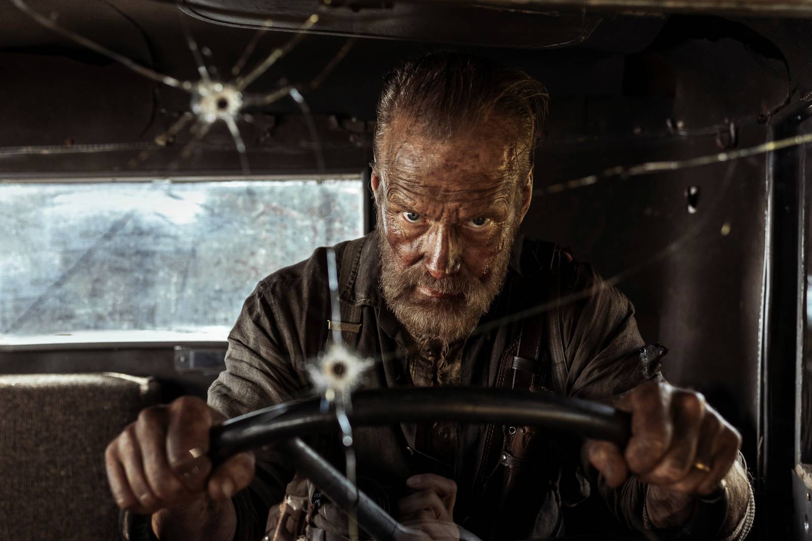 Aatami Korpi (Jorma Tommila) glares from the driver's seat of a truck in Sisu: Road to Revenge