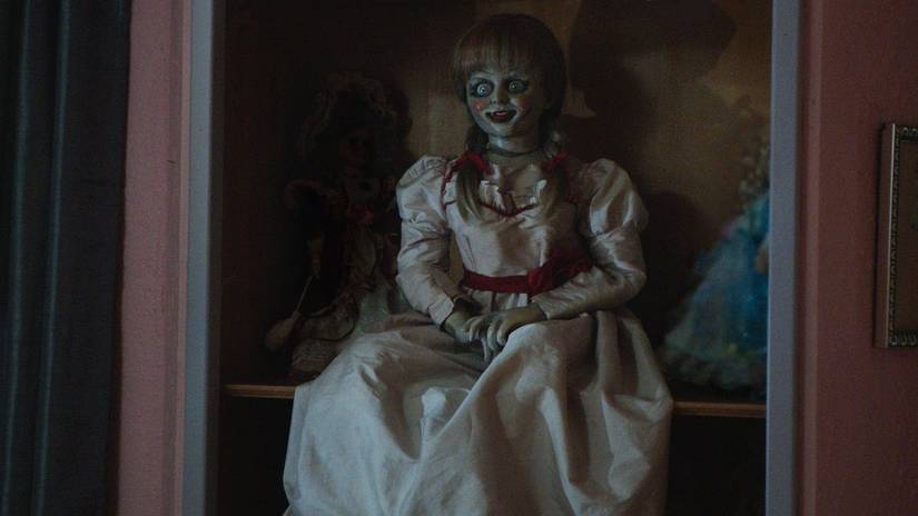 The Annabelle doll in a dimly lit setting