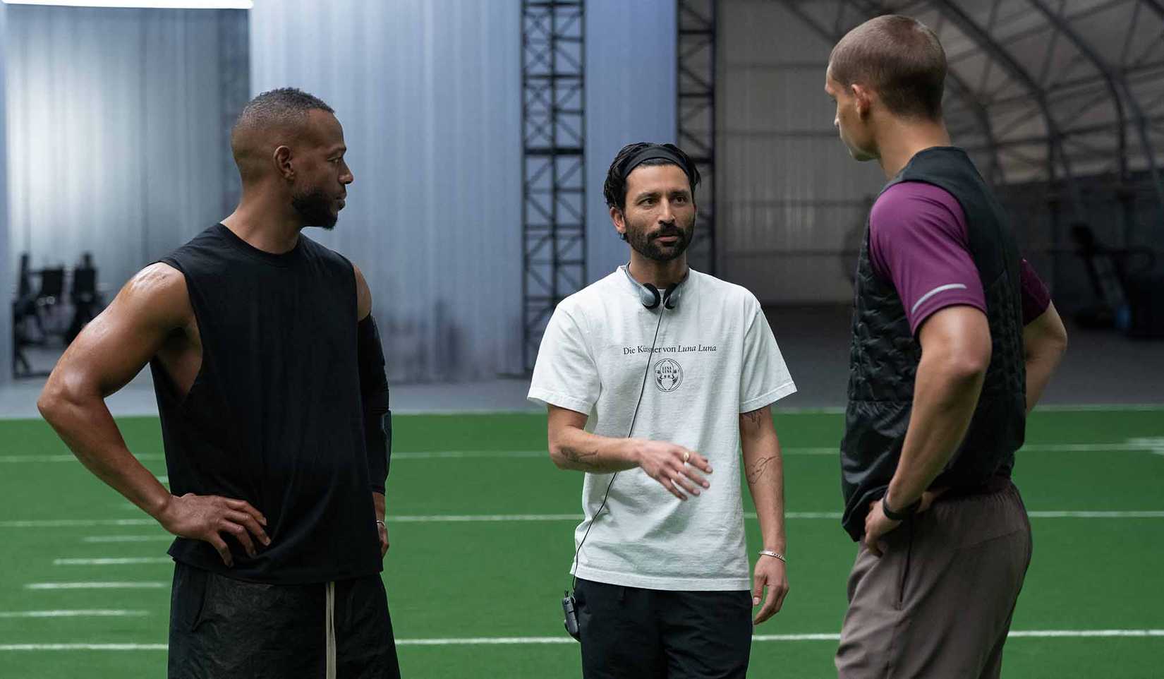 Him director Justin Tipping speaks to actors Tyriq Withers and Marlon Wayans on the set of Him