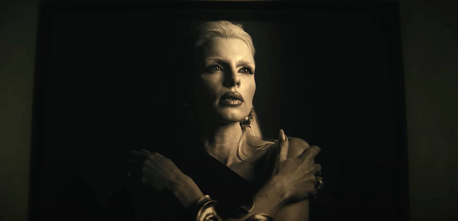 Julia Fox in Him — sepia portrait with arms crossed