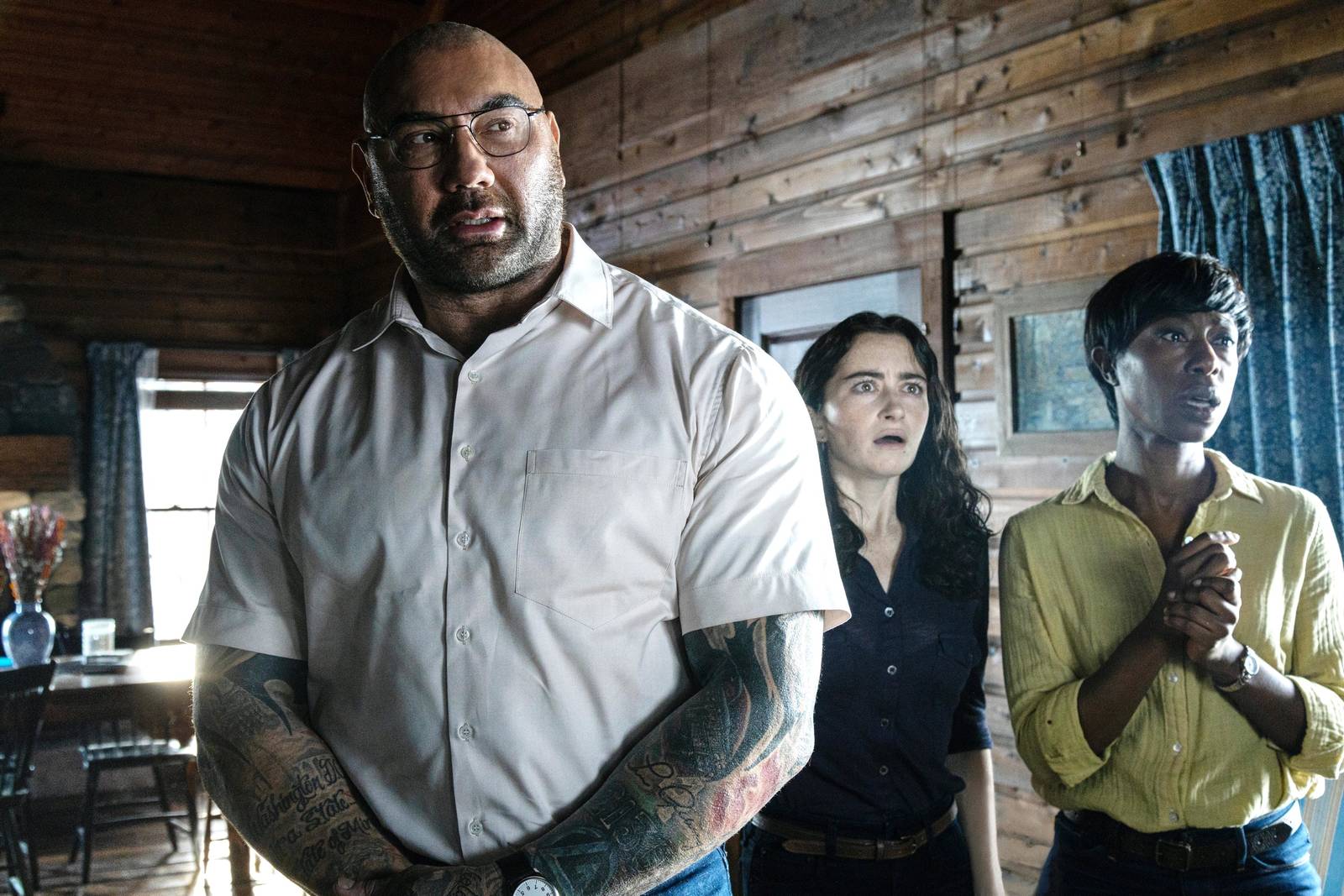Dave Bautista and the cast of Knock at the Cabin reacting in the cabin
