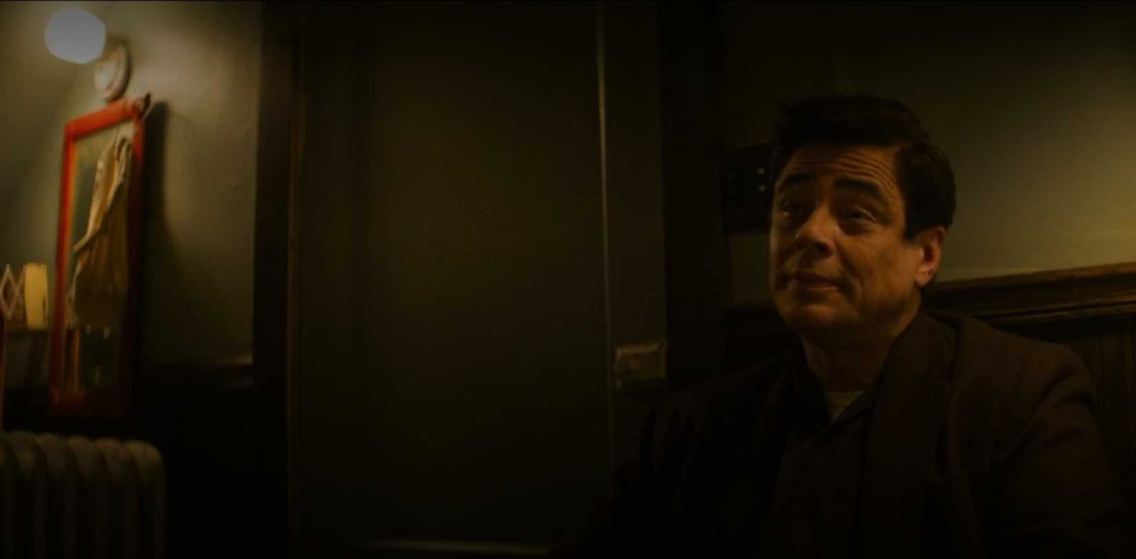 Benicio del Toro lurks in the shadows in a scene from the film No Sudden Move