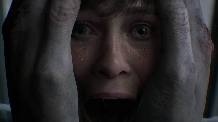 A screaming face held between two giant gray hands in OD