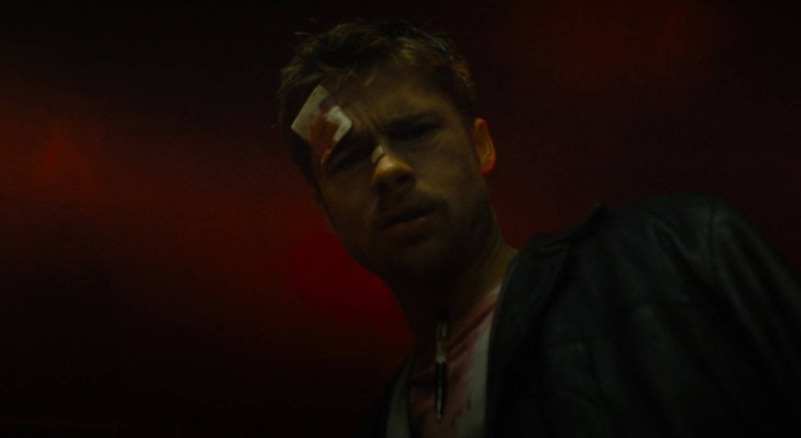 Brad Pitt covered in blood inspects a serial killer's emptied apartment in a scene from Seven