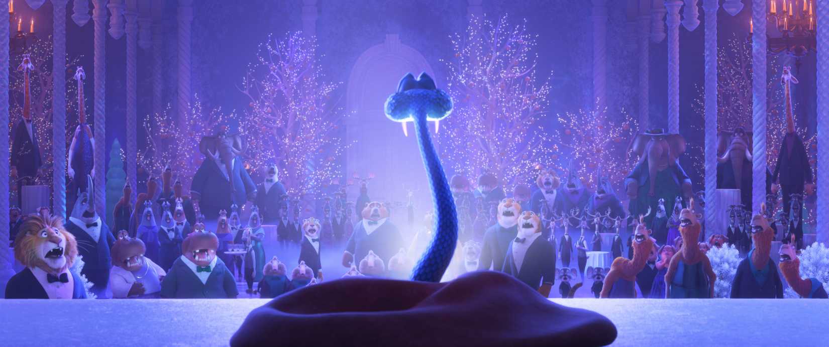 A blue snake, seen from behind, rears up on a stage as an auditorium full of anthropomorphic animals look on and gasp in Zootopia 2