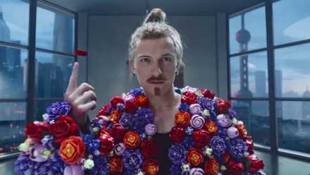 Tom Holland wearing the flowers from Midsommar in a LEGO commercial