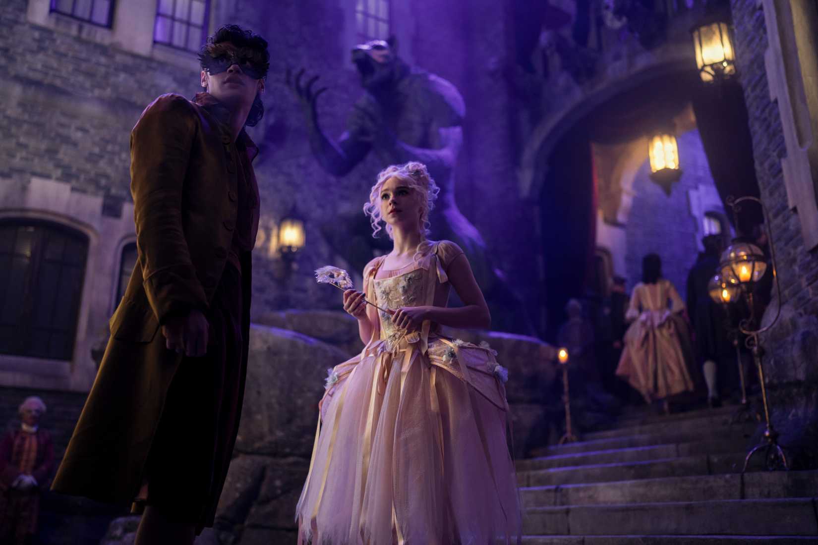 Image featuring Enid Sinclair and Bruno from Wednesday. They are both in fancy dress, with Bruno wearing a mask.