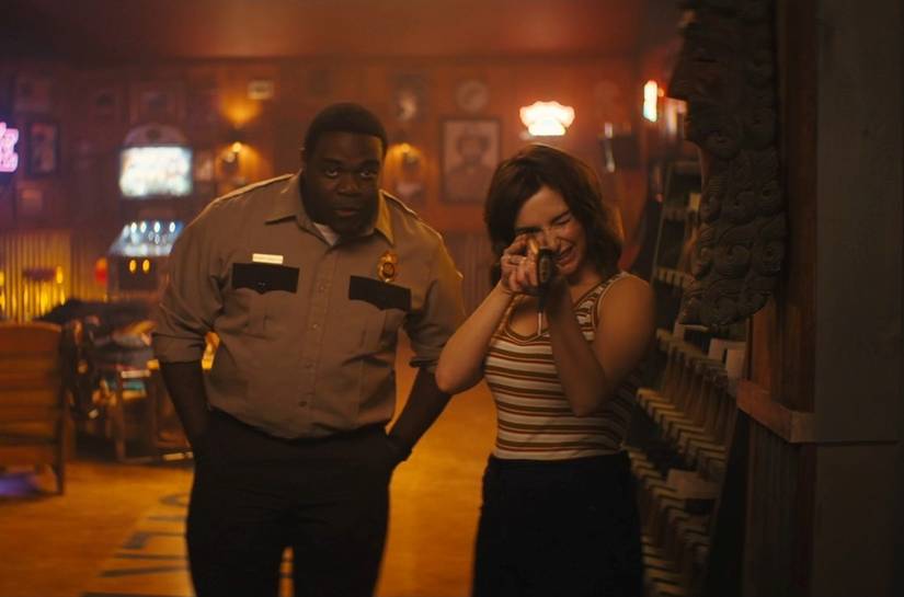 Sam Richardson and the girl from a bunch of AT&T ads practice axe-throwing in a scene from the video game adaptation Werewolves Within