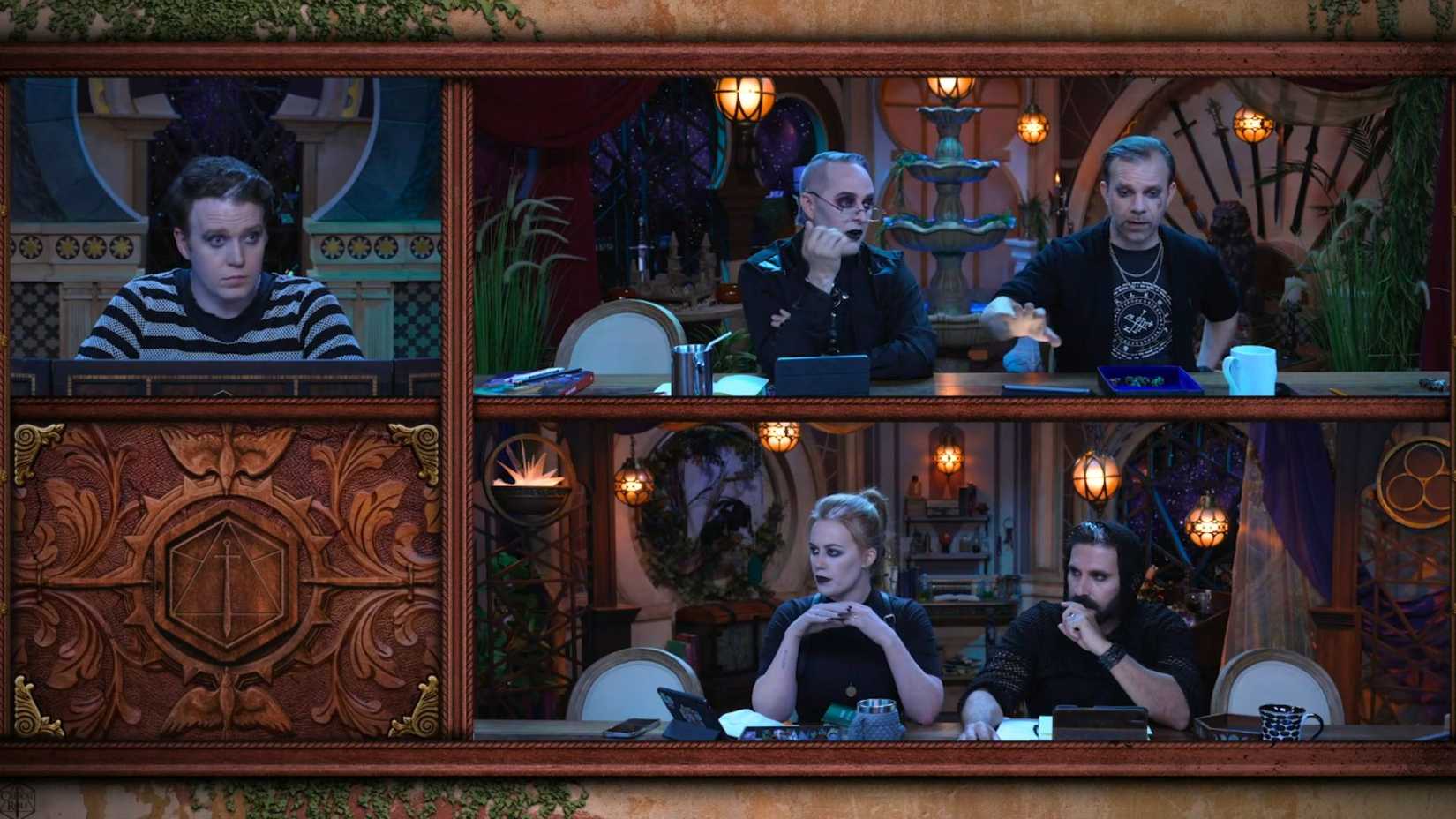 Screenshot of Critical Role Campaign 4 episode 4. It features Brennan Lee Mulligan, Marisha Ray, Luis Carazo and Liam O'Brien. They are sitting at a table, all wearing gothic attire. 
