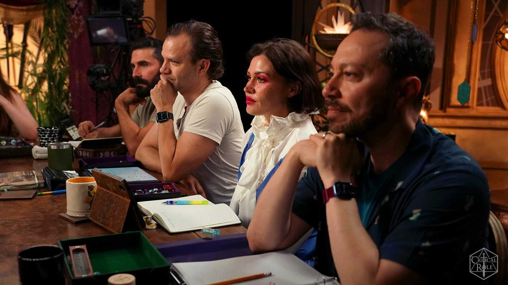 Key image of Critical Role's campaign 4 cast. It features Luis Carazo, Liam O'Brien, Whitney Moore and Sam Riegel sat at a table.