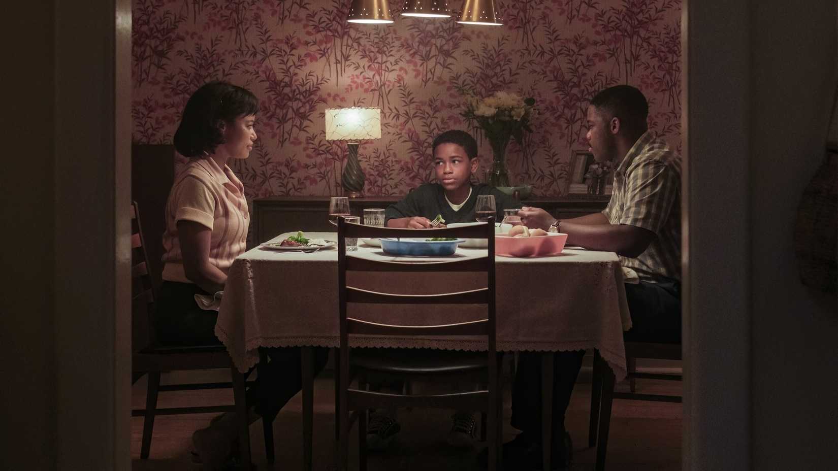 Charlotte, Leroy, and Will Hanlon (Taylour Paige, Blake Cameron James, Jovan Adepo) sitting at the dinner table from IT: Welcome to Derry