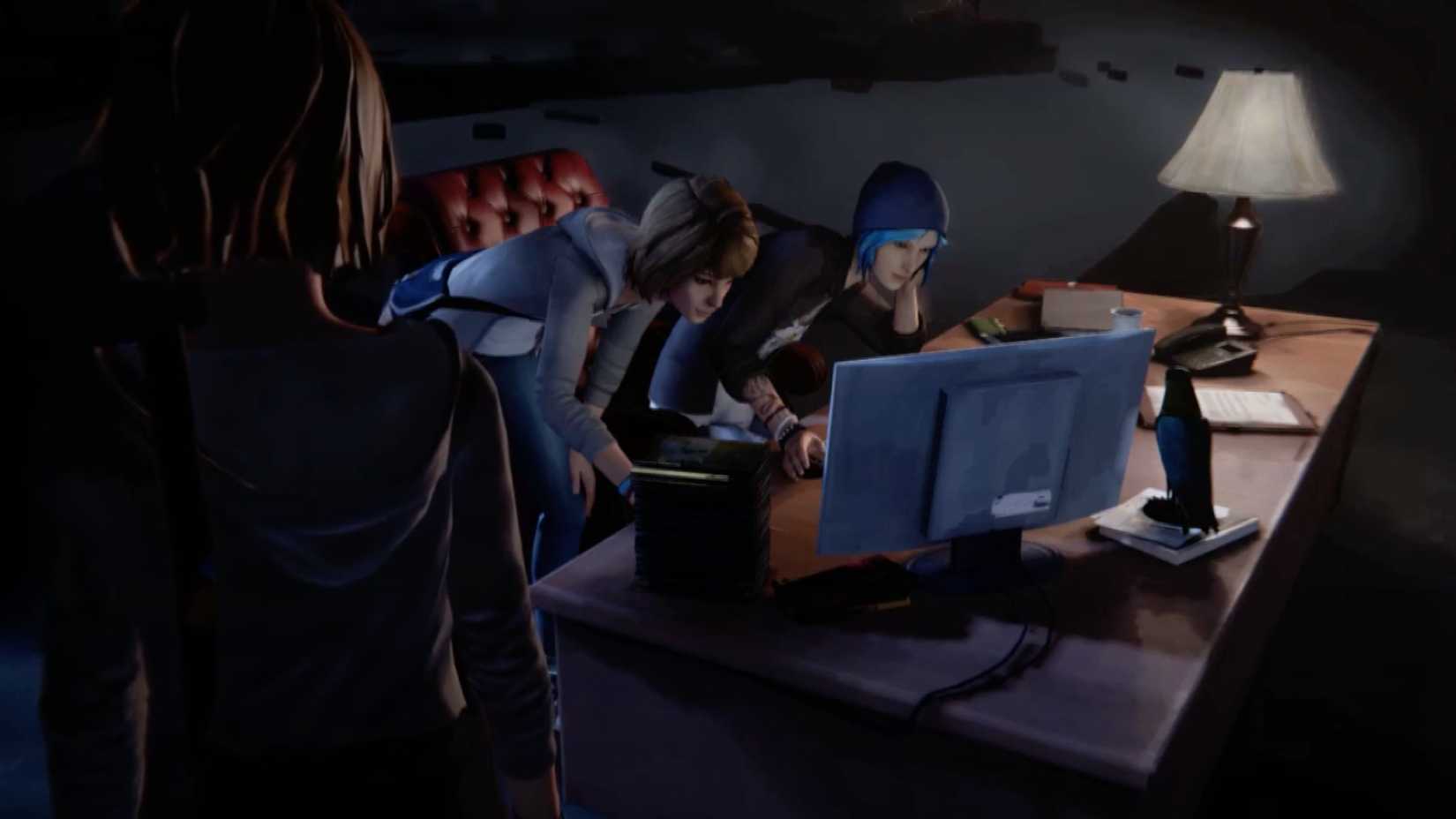 Chloe and Max crowd around a desktop PC, staring at something on the screen.