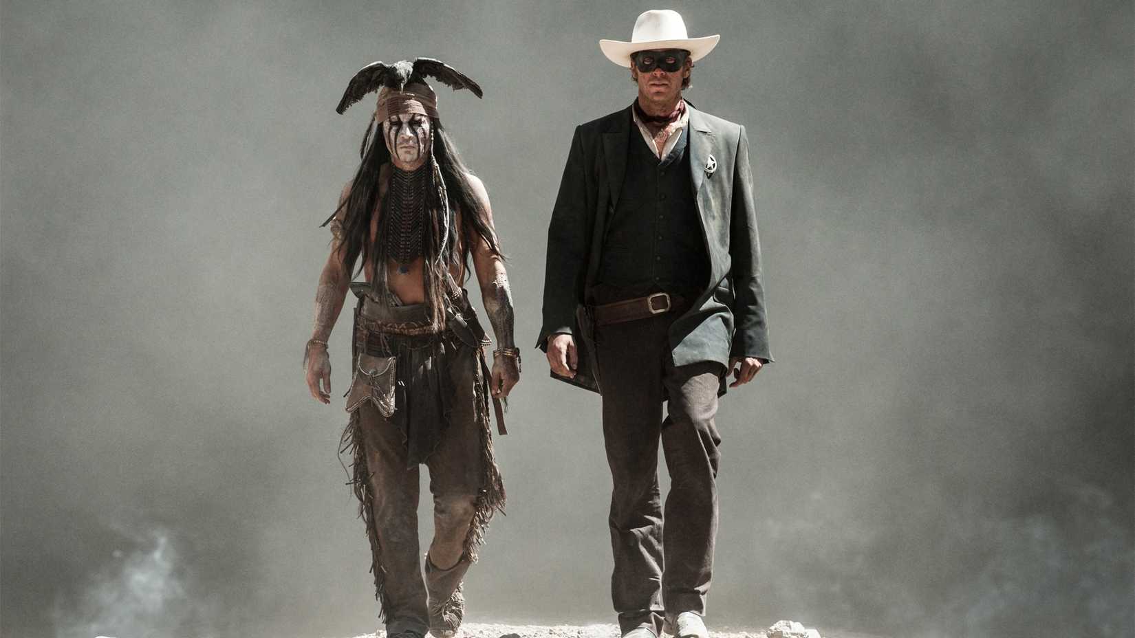 Johnny Depp and Armie Hammer walk toward the camera in a scene from the 2013 film of The Lone Ranger, unaware of the personal problems that await them in the future.