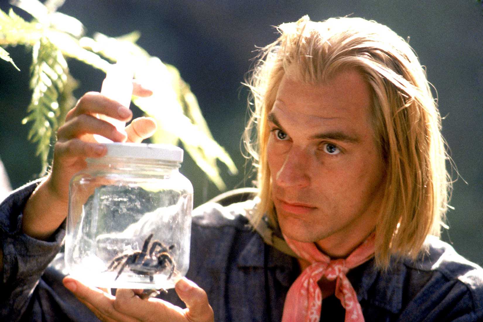 Julian Sands holds a jar with a large spider in Arachnophobia