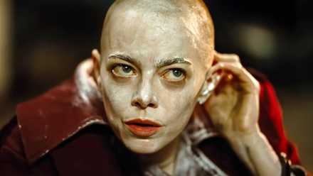 Emma Stone bald and smeared with white lotion in Bugonia