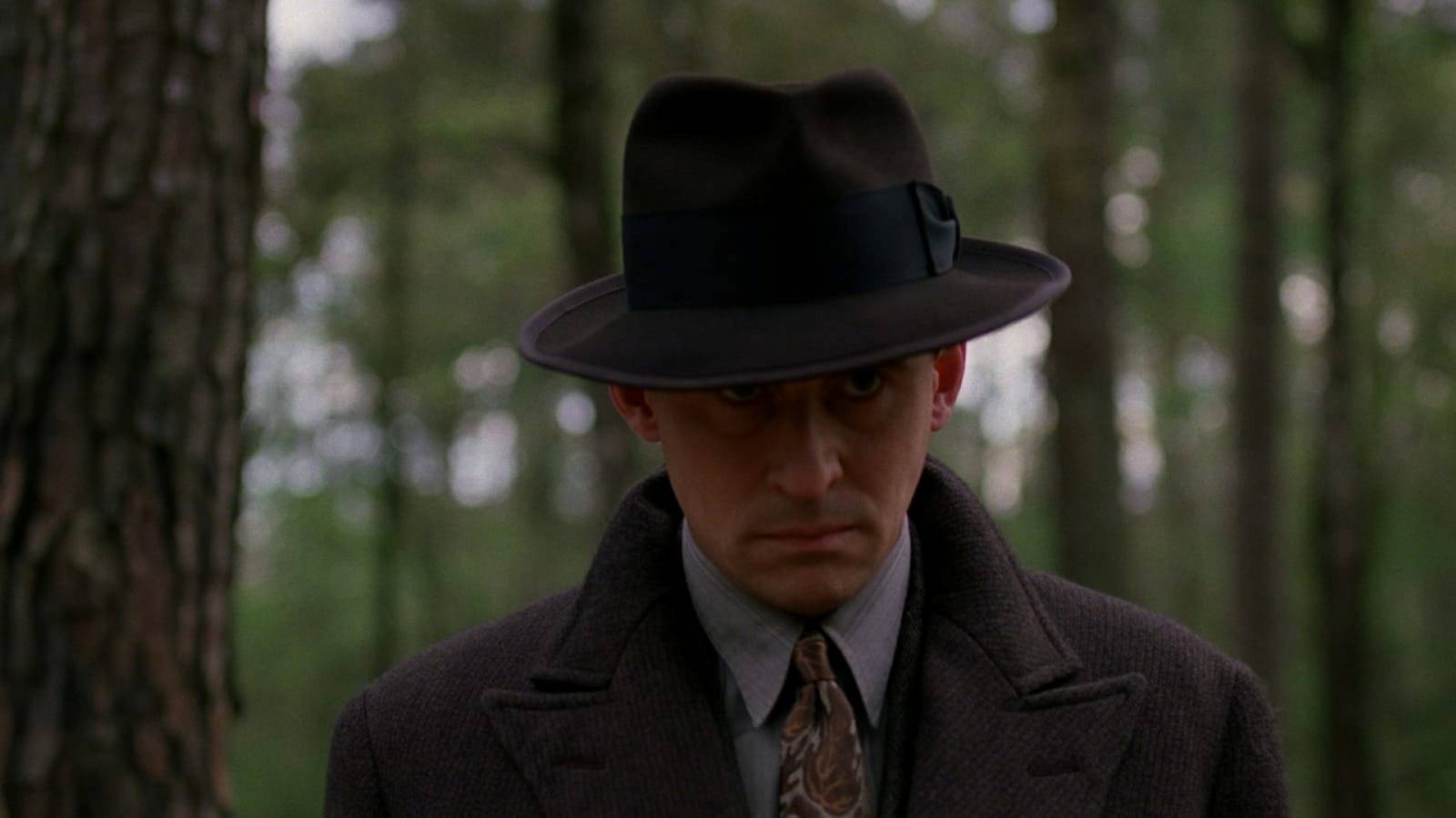 Gabriel Byrne as Tom Reagan, the laconic antihero of Miller's Crossing, wearing a fedora