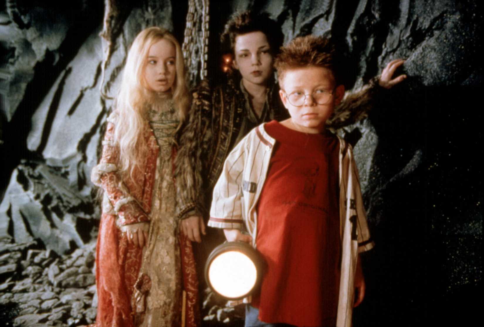 Image showing Anna, Tony and Rudolph in a cavernous area. Tony holds a large flashlight.