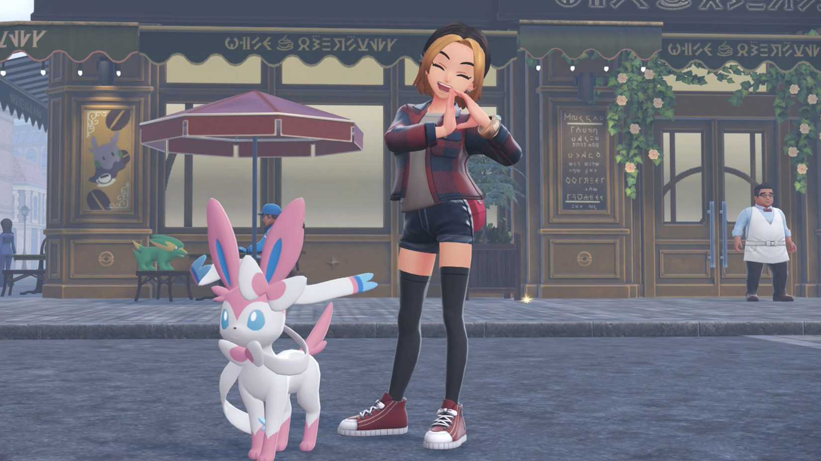 A trainer poses with a D-shape in her hands with a Sylveon in Pokémon Legends: Z-A.