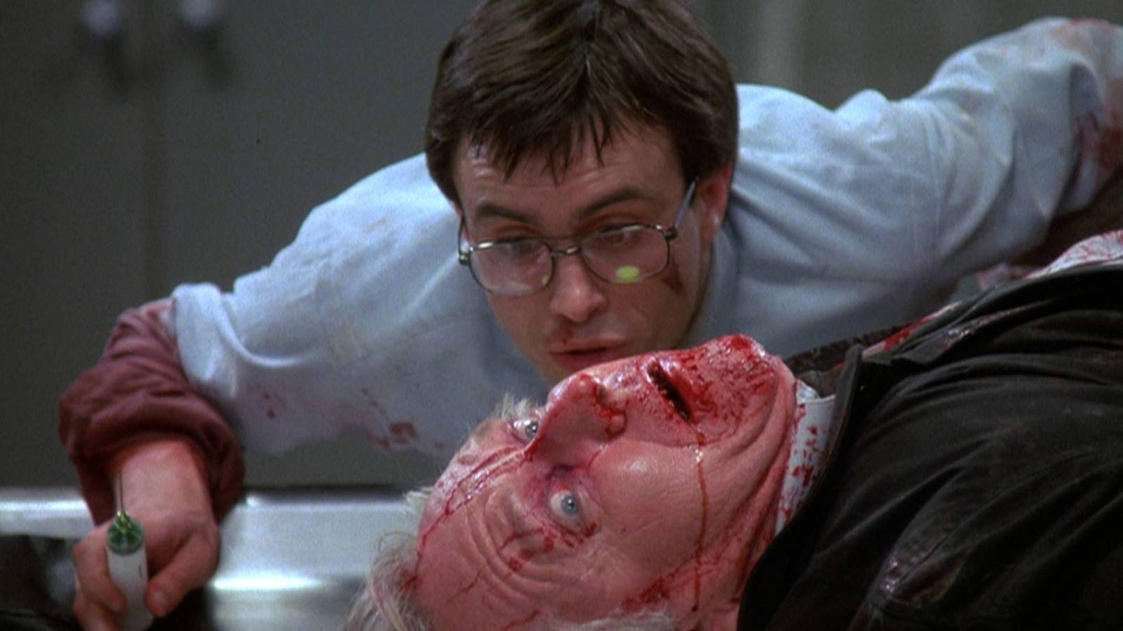 Herbert West injects his serum into a corpse in Re-Animator