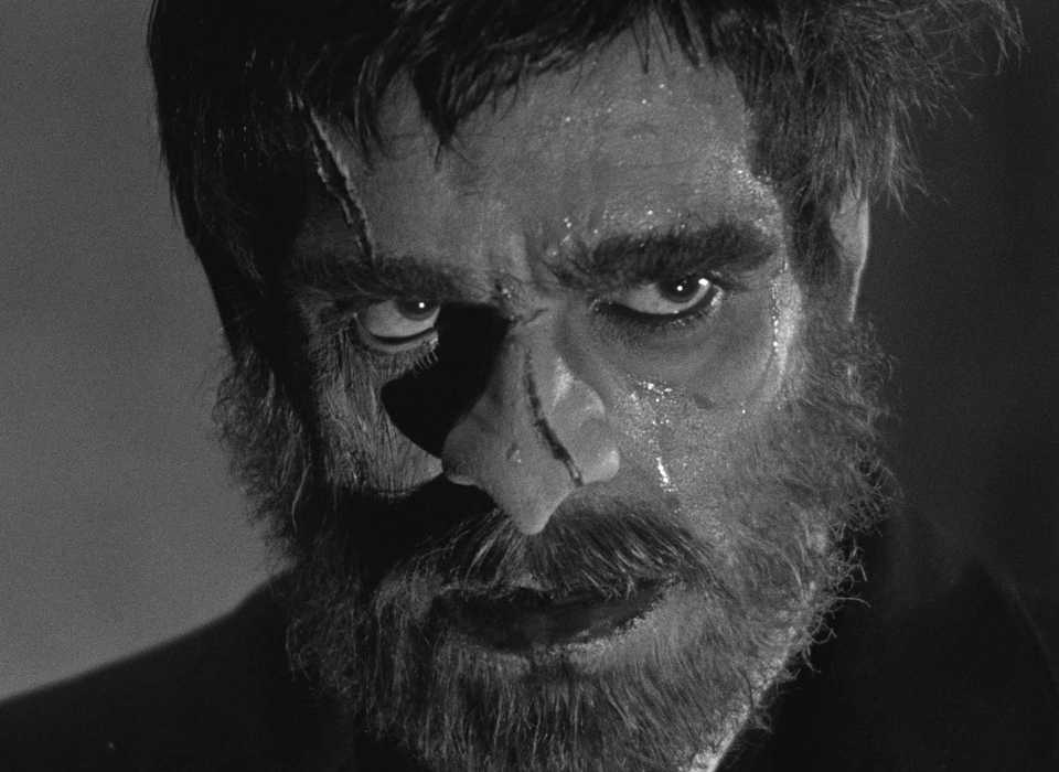 Boris Karloff, bearded and sweaty and with gashes on his face, as his mute, mysterious character from The Old Dark House