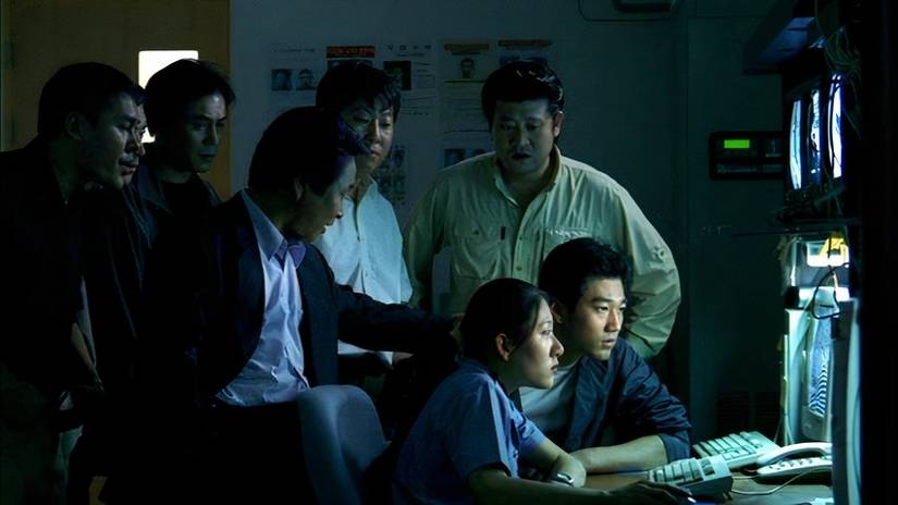 Police officers gather around a screen, Save the Green Planet!