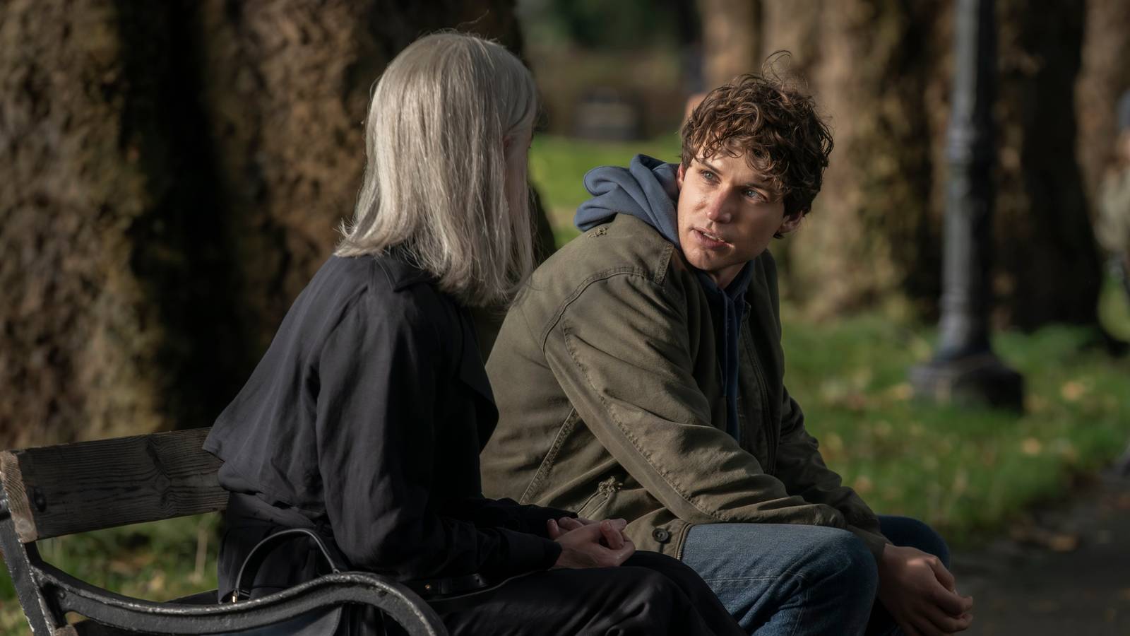 Guy Anatole (Nicholas Denton) and Helen (Elizabeth McGovern) sit on a bench in Talamasca