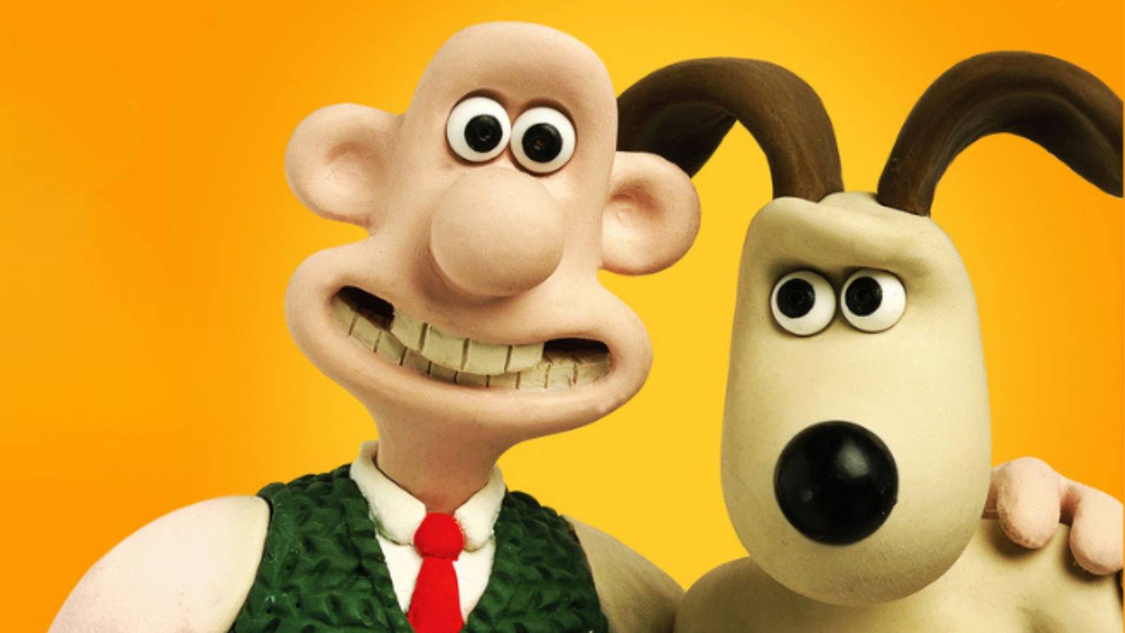 Promotional image of Wallace and Gromit from The Curse of the Were-Rabbit — Wallace smiles with his hand on Gromit's shoulder.