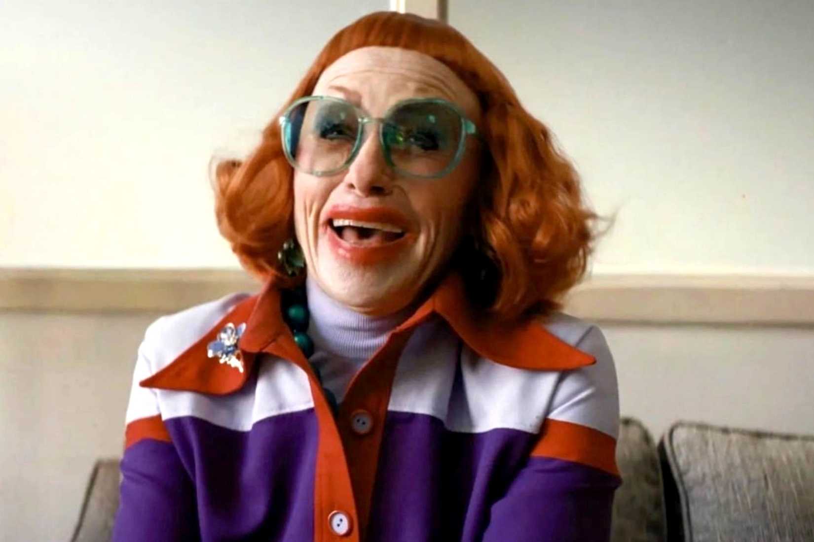 Weapons' Aunt Gladys aka Amy Madigan wearing a red wig and hideous amounts of lipstick