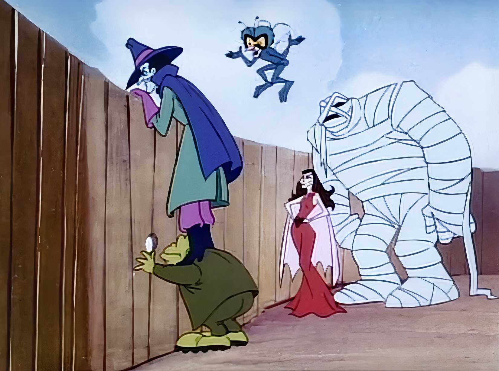 The members of OGRE — blue-skinned human Dr. Dred, toadlike Toad, hulking Mummy Man, bug-eyed Fly, and the Morticia-esque Vampira — stand by a wooden fence, peering over it or through knotholes, in Drak Pack
