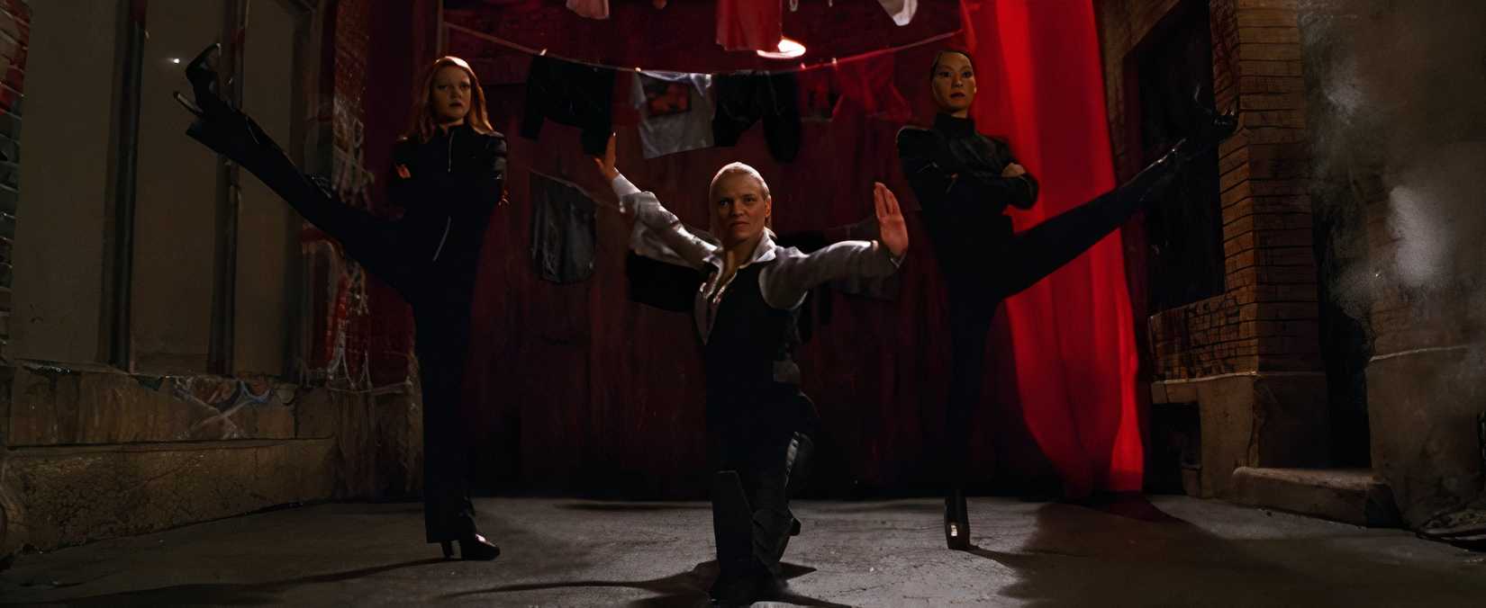 In a scene from Charlie's Angels, Drew Barrymore, Cameron Diaz, and Lucy Liu assume a group kung-fu pose, as was the style at the time.