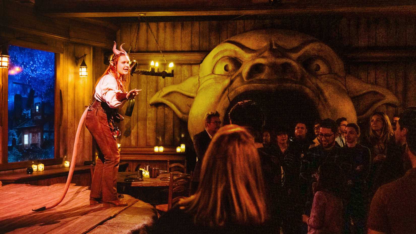 Players at Dungeons & Dragons: The Immersive Quest gather at the Yawning Portal to learn about their quest