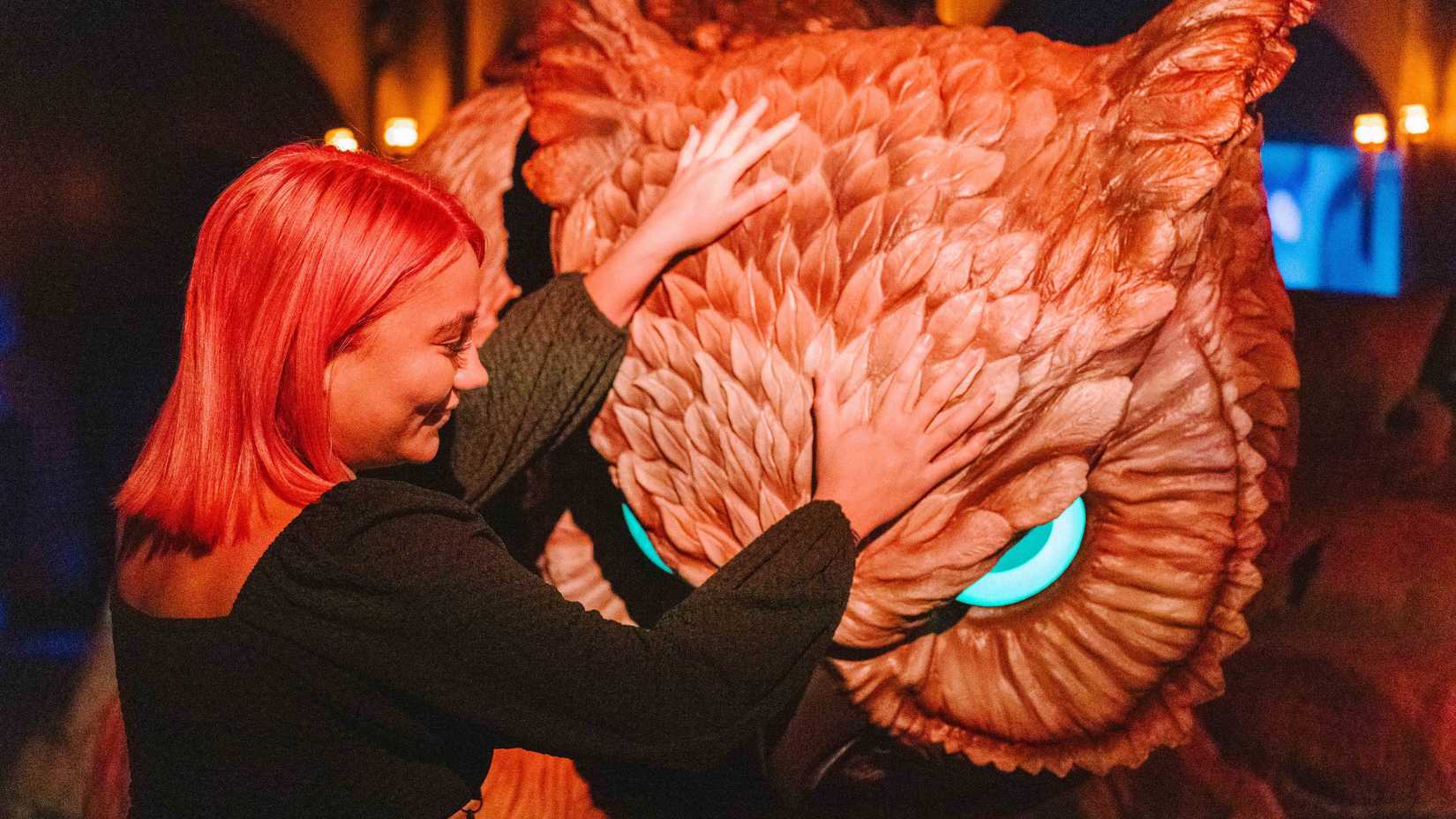 A woman pets an owlbear in Dungeons & Dragons: The Immersive Quest.