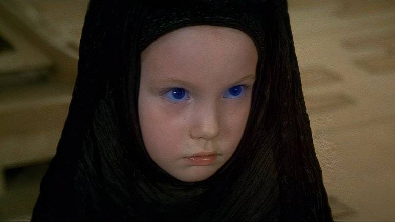 A young Alia in a black cowl with glowing blue eyes in David Lynch's Dune