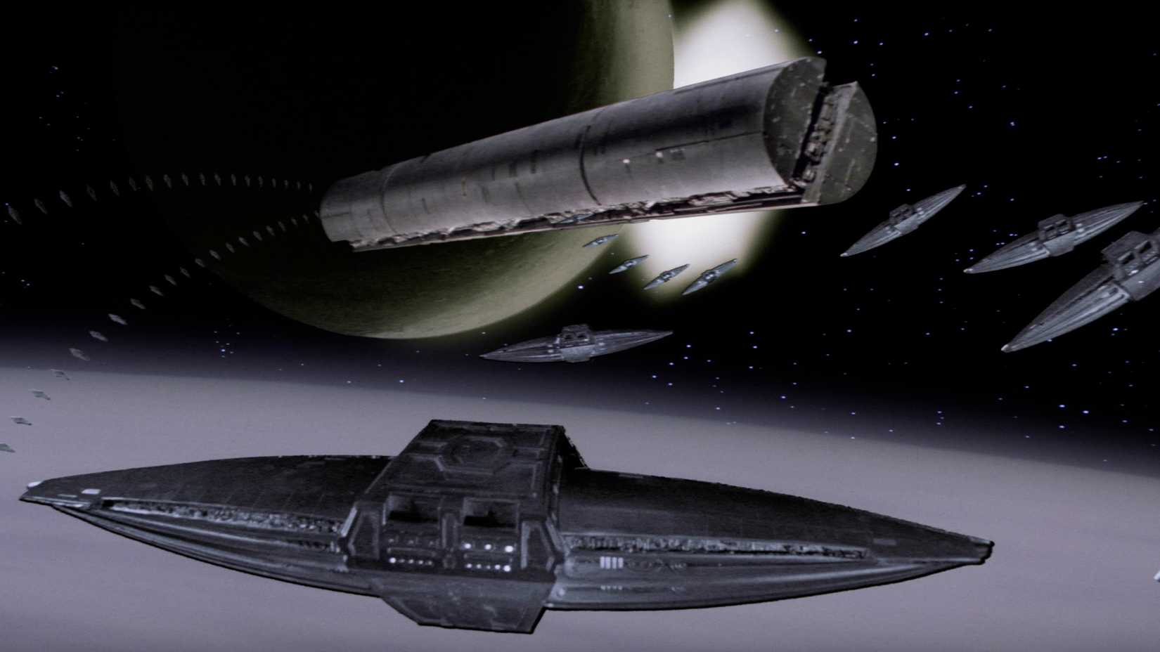 Lozenge-shaped spacecraft approaching a massive cigar-shaped ship in David Lynch's Dune