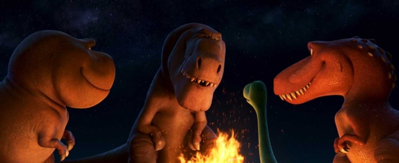 A group of T. rexes and a smaller dinosaur gather around a campfire in The Good Dinosaur.
