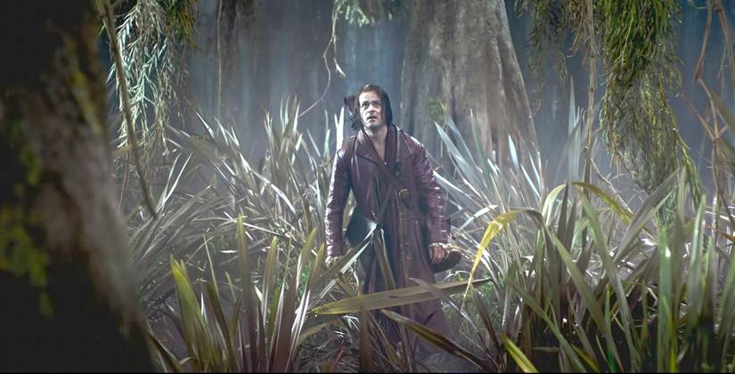 Jaskier (Joey Batey) moving through the swamp in The Witcher season 4