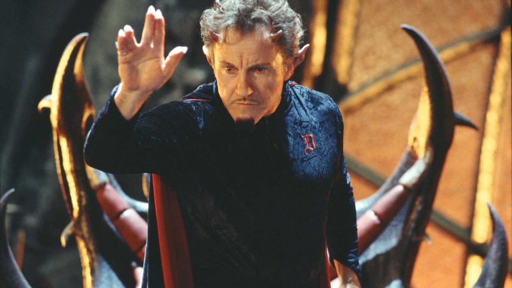 Harvey Keitel as the Devil raising his hand in Little Nicky