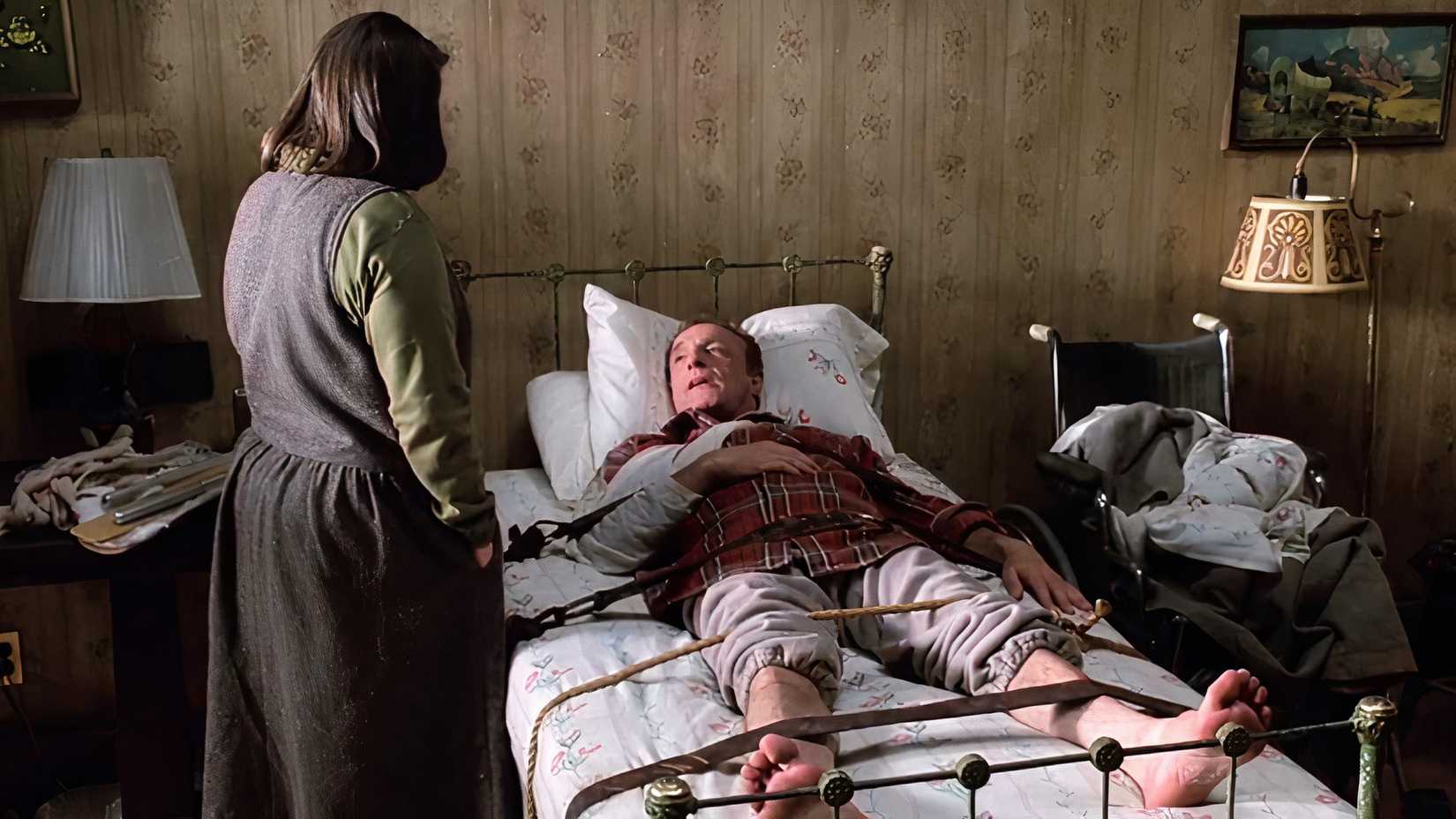 Paul restrained on a bed in Annie's house